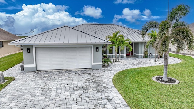 view of front of house with a garage and a front lawn