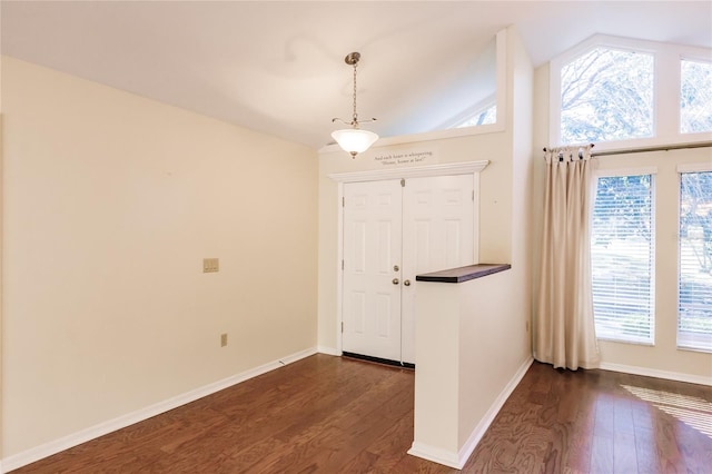 entryway featuring dark hardwood / wood-style flooring and vaulted ceiling