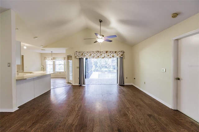 unfurnished living room with dark hardwood / wood-style flooring, ceiling fan, and lofted ceiling