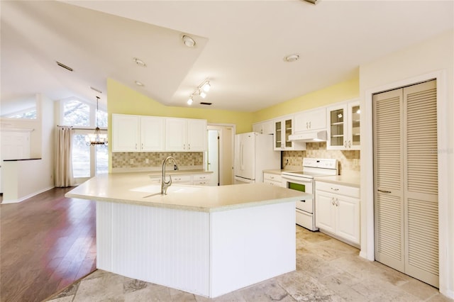 kitchen featuring white cabinets, white appliances, vaulted ceiling, and backsplash