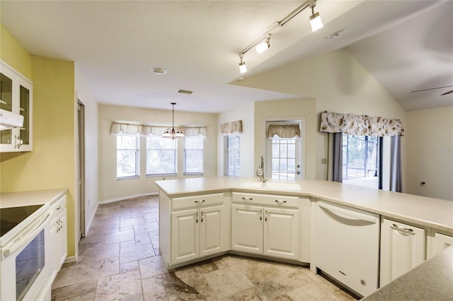 kitchen featuring dishwasher, stove, white cabinetry, and plenty of natural light