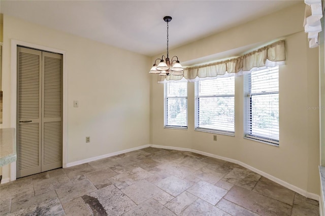 spare room featuring a chandelier