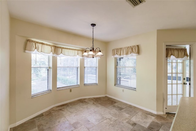 unfurnished dining area featuring a notable chandelier