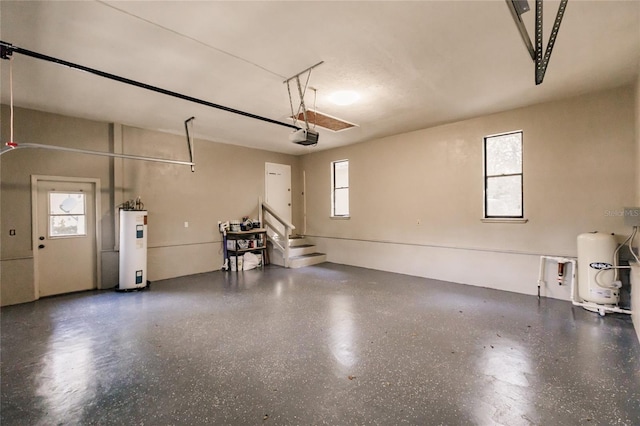 garage featuring electric water heater and a garage door opener