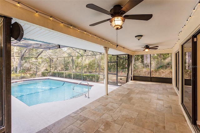 view of swimming pool with a patio area and a lanai