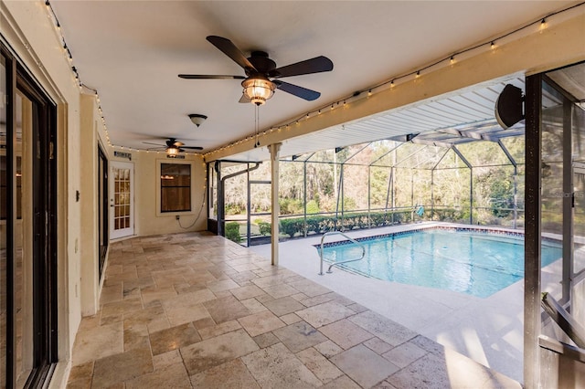 view of pool featuring glass enclosure and a patio