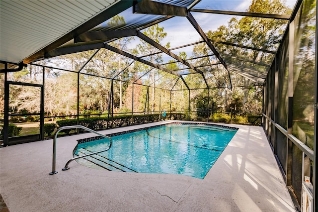 view of pool with a patio and glass enclosure