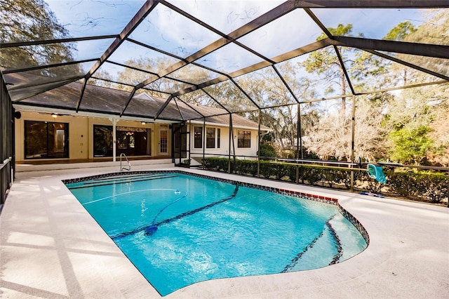 view of pool with a patio, ceiling fan, and a lanai