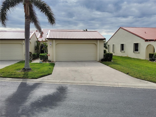 view of front of home with a garage and a front lawn