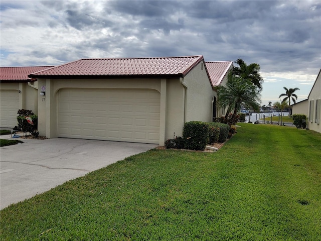 view of side of home featuring a garage and a yard