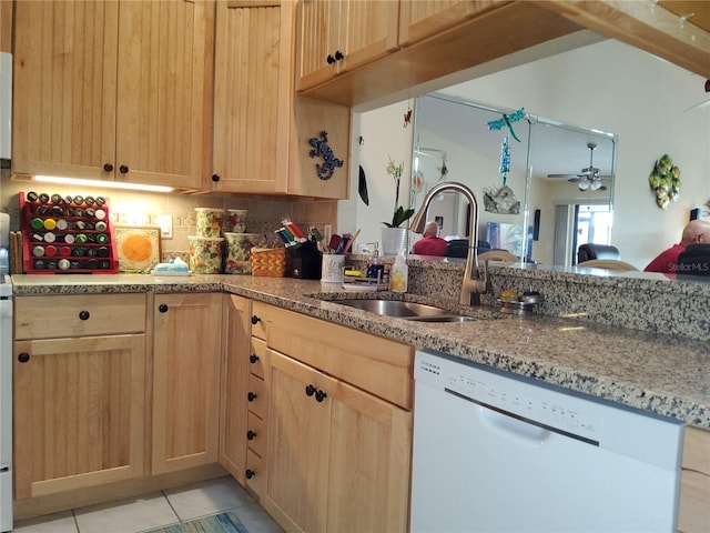 kitchen with tasteful backsplash, light tile patterned flooring, light brown cabinetry, dishwasher, and sink