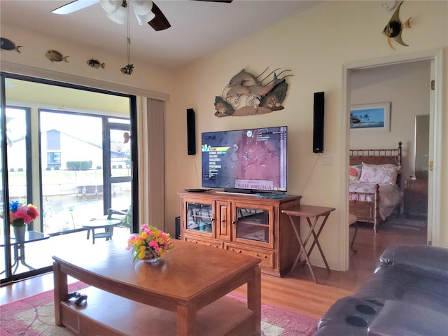 living room featuring ceiling fan and hardwood / wood-style flooring