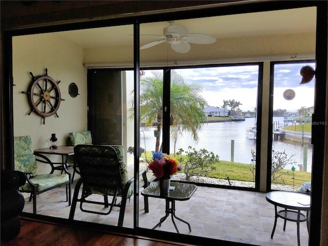 interior space featuring a water view and ceiling fan