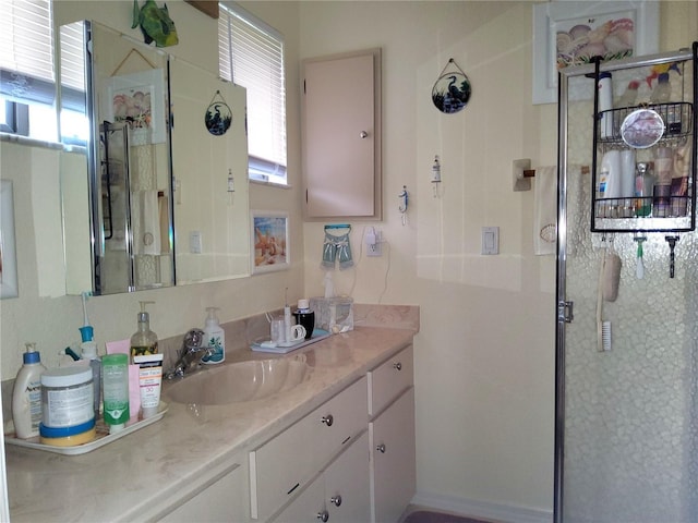 bathroom featuring plenty of natural light, walk in shower, and vanity