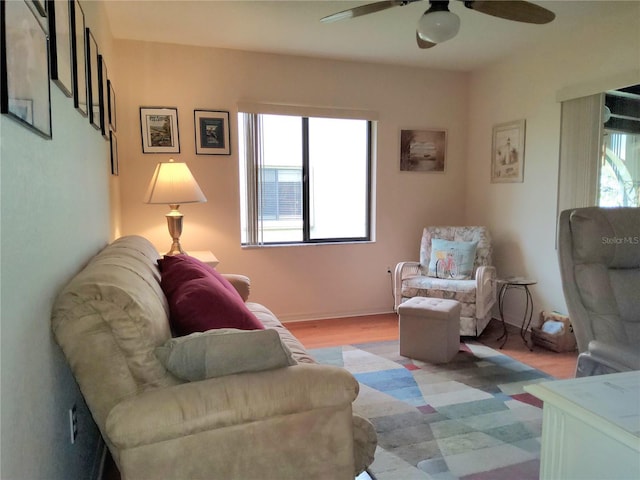 living room featuring light wood-type flooring and ceiling fan