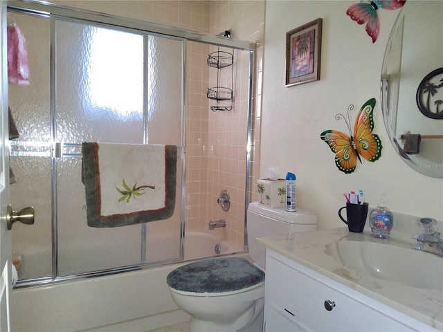 full bathroom with toilet, vanity, and enclosed tub / shower combo