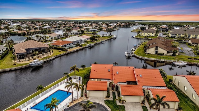 aerial view at dusk with a water view