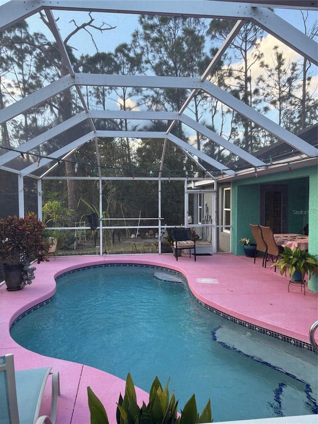 view of pool with a lanai and a patio