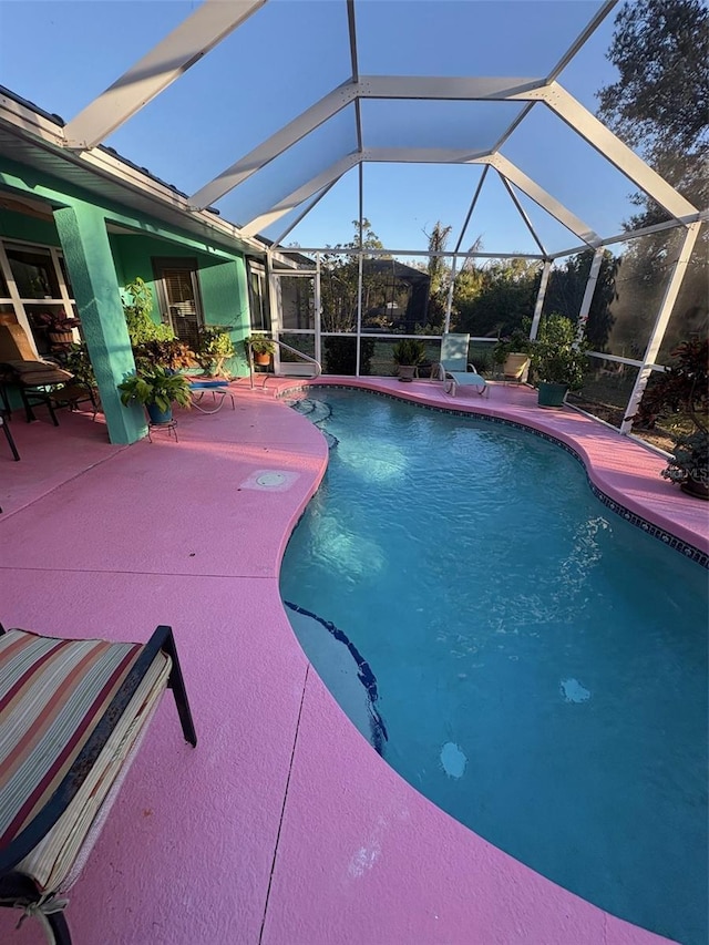 view of pool featuring glass enclosure and a patio