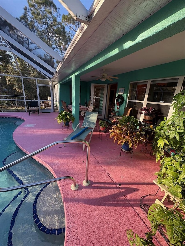 view of patio / terrace with ceiling fan and a lanai