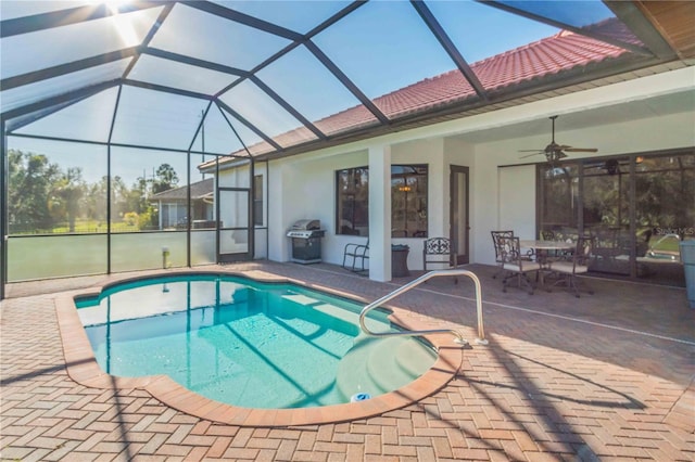 view of pool featuring ceiling fan, area for grilling, a patio, and glass enclosure