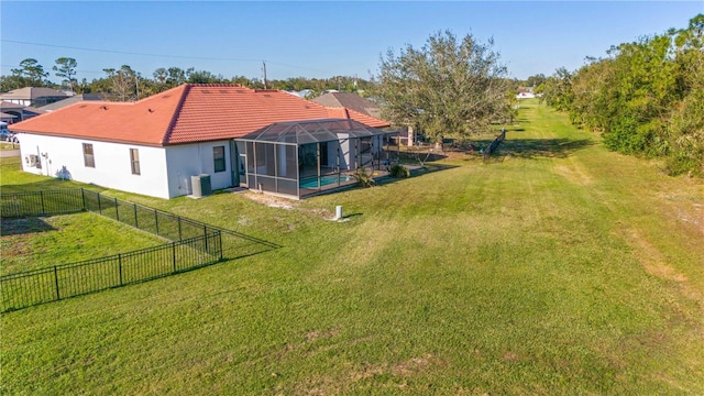 view of yard with a lanai and a fenced in pool