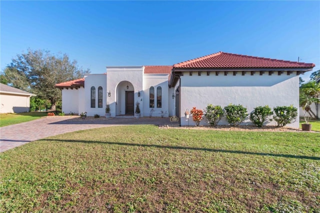 mediterranean / spanish-style house with a front lawn