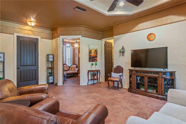 living room with ceiling fan and ornamental molding