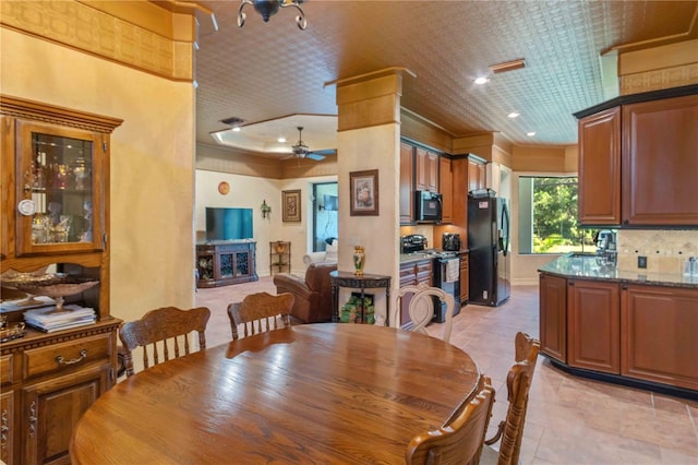 dining room with ceiling fan and crown molding