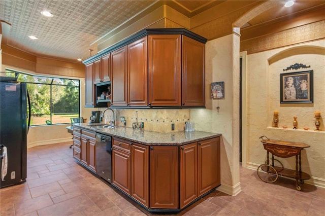 kitchen with black appliances, light stone countertops, and sink