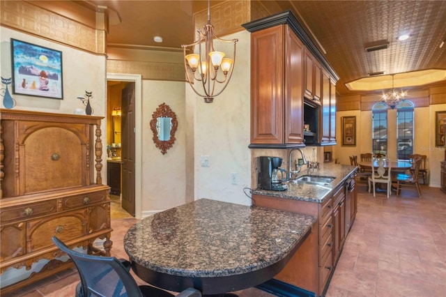 kitchen with sink, a notable chandelier, dark stone countertops, crown molding, and decorative light fixtures