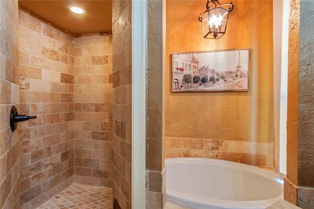 bathroom with independent shower and bath and a notable chandelier