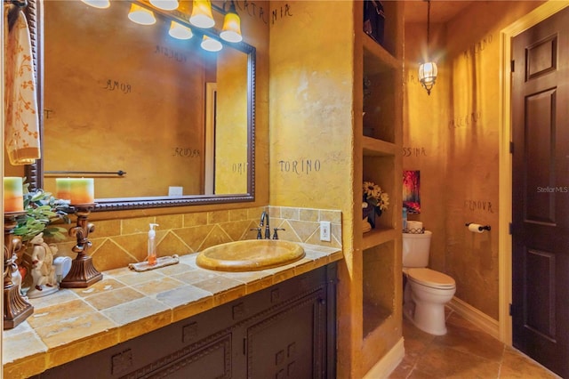 bathroom with tile patterned floors, decorative backsplash, toilet, and vanity