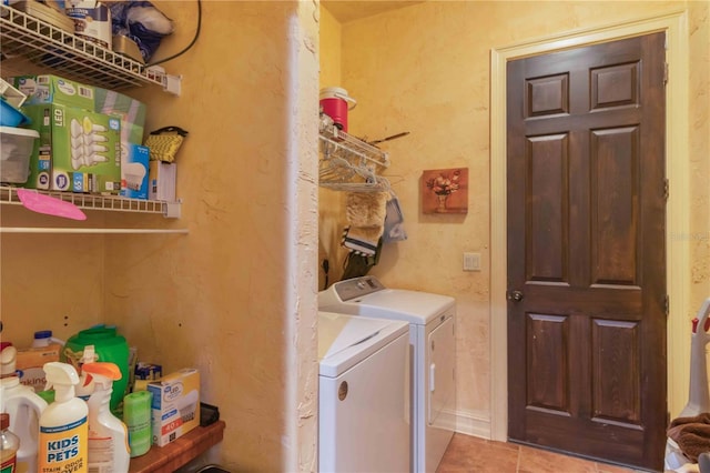 laundry room featuring washer and clothes dryer and light tile patterned floors