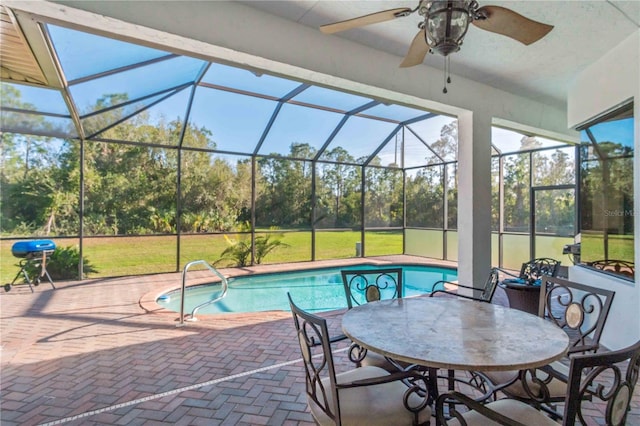 view of swimming pool with a lanai, a patio area, and ceiling fan