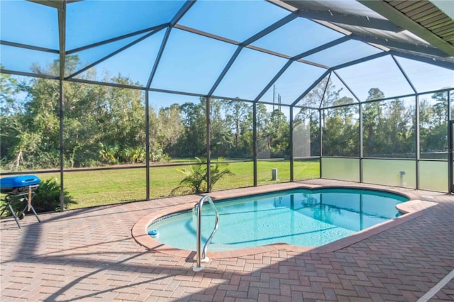 view of swimming pool featuring glass enclosure, a yard, and a patio