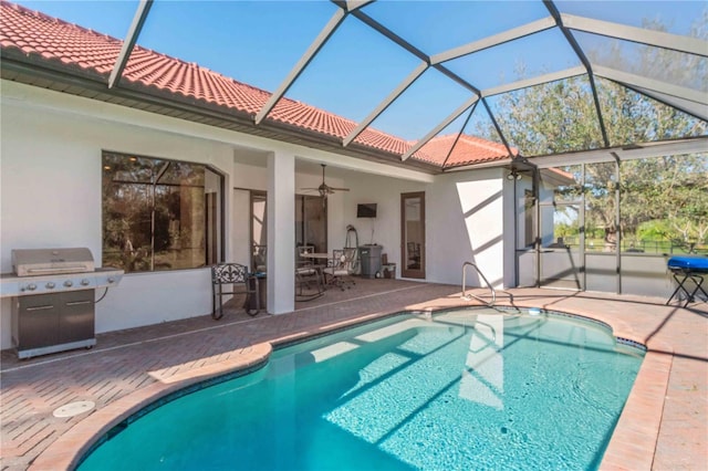 view of swimming pool with a lanai, a patio area, ceiling fan, and grilling area