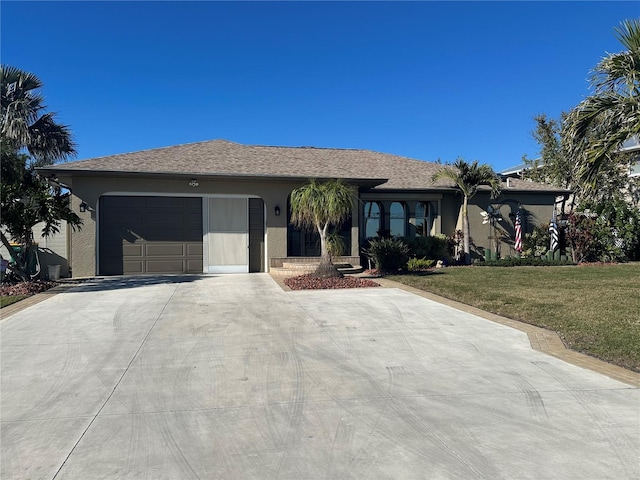 single story home with a garage and a front lawn