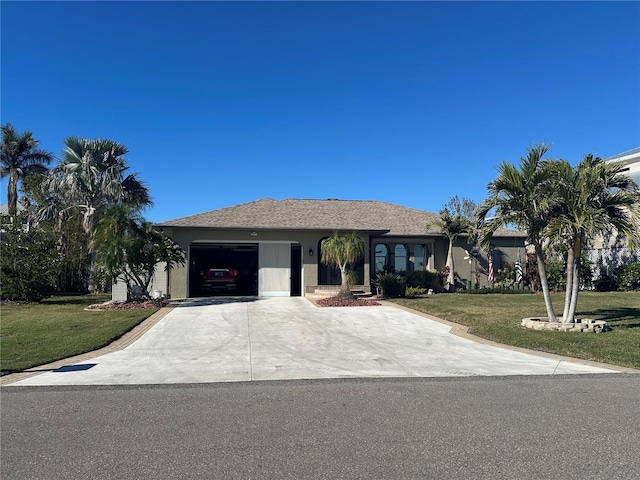 ranch-style house featuring a garage and a front lawn