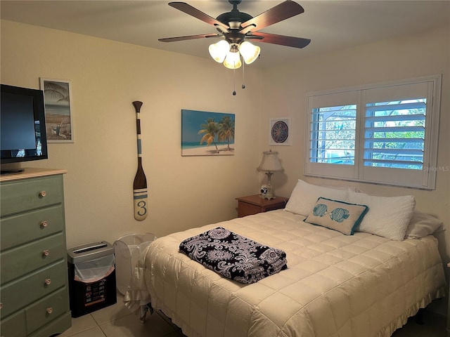 tiled bedroom with ceiling fan