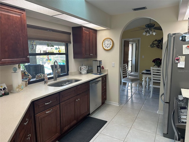 kitchen with ceiling fan, stainless steel appliances, sink, and light tile patterned floors