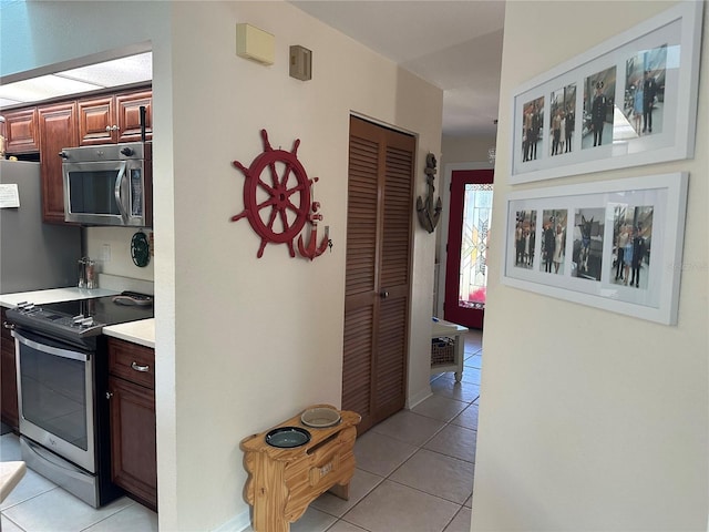 kitchen with appliances with stainless steel finishes and light tile patterned floors