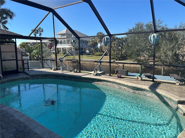 view of swimming pool featuring glass enclosure