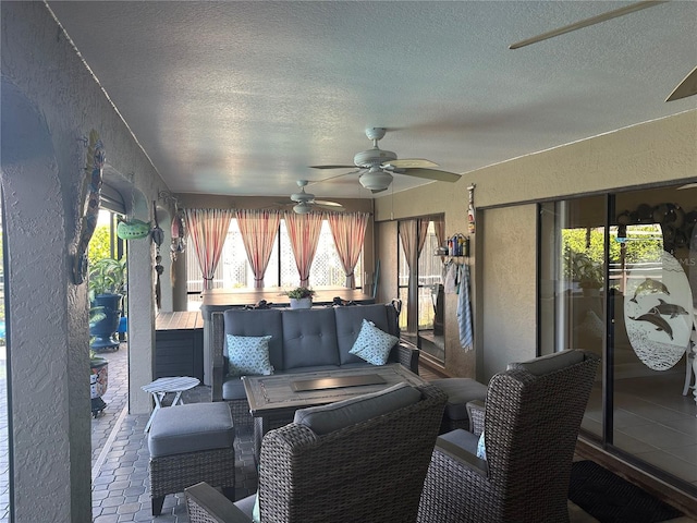 sunroom / solarium featuring ceiling fan