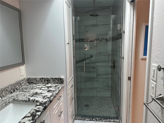 bathroom with vanity and a shower with door