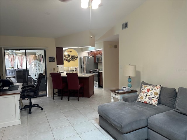 living room featuring light tile patterned flooring, lofted ceiling, and ceiling fan