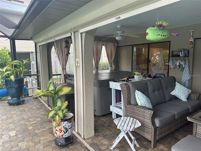 view of patio / terrace featuring outdoor lounge area, ceiling fan, and a hot tub