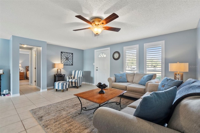 tiled living room with a textured ceiling and ceiling fan