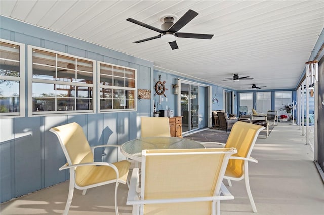 sunroom / solarium featuring ceiling fan