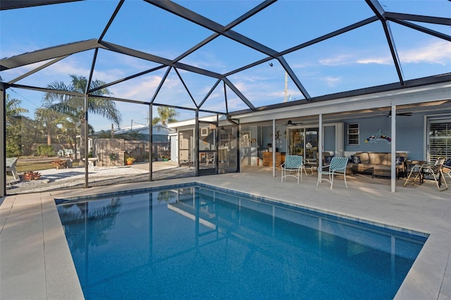 view of pool with ceiling fan, a patio area, and a lanai